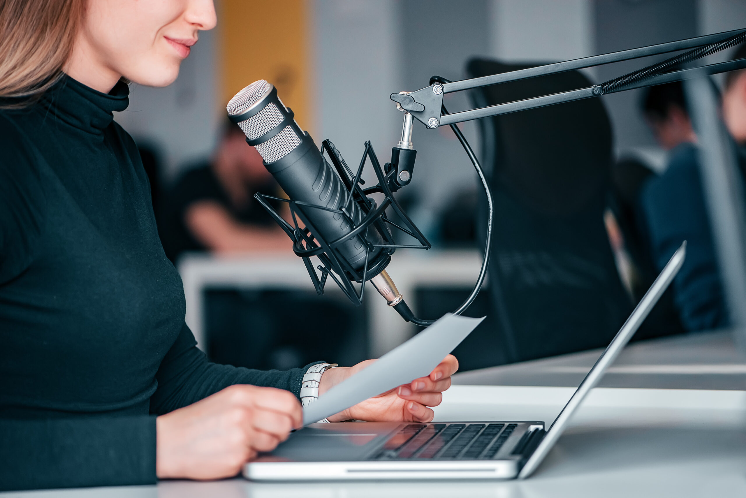 Young woman recording a podcast in a studio